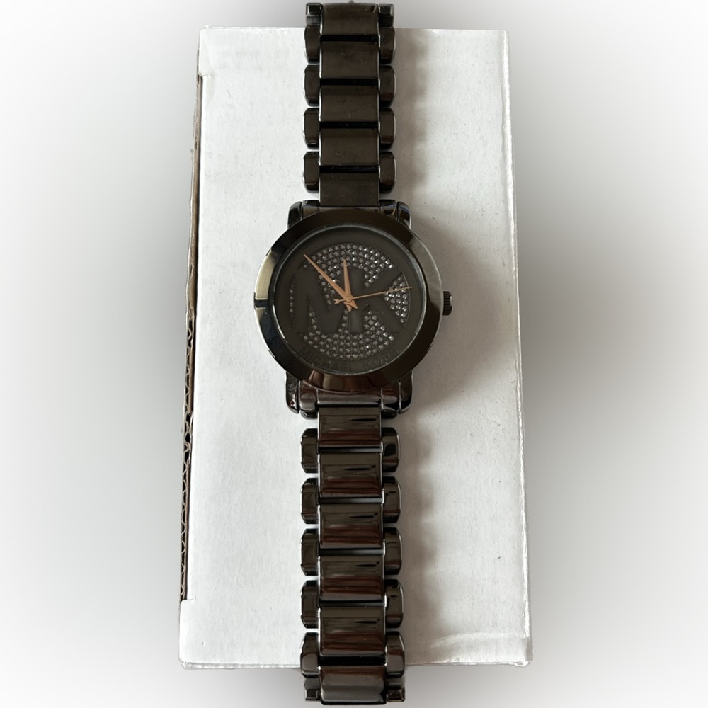 This is a women’s Michael Kors Runway watch in gunmetal with a crystal pave dial